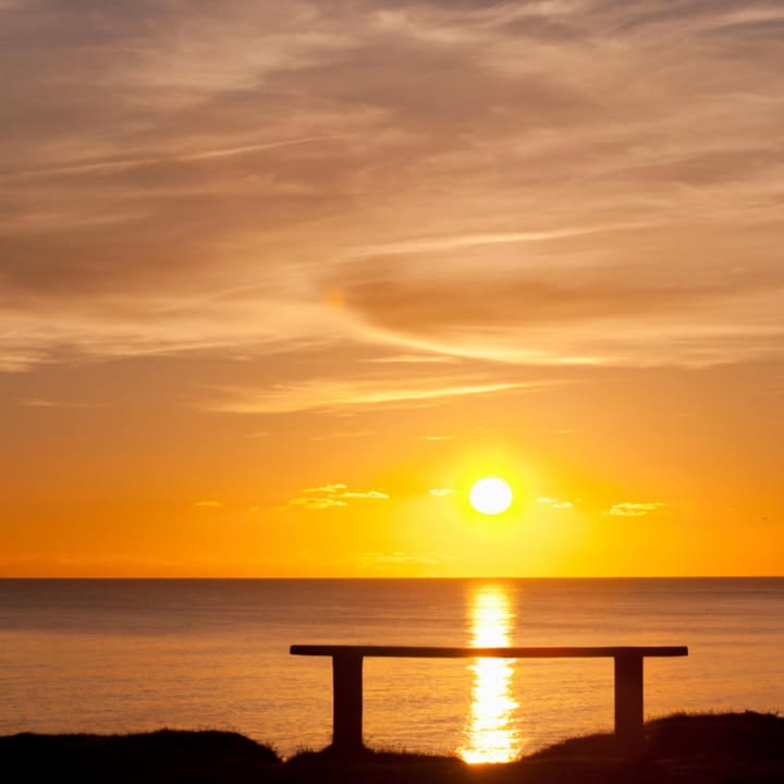 A golden sunset reflected on the ocean, from our original SeaBurial social page